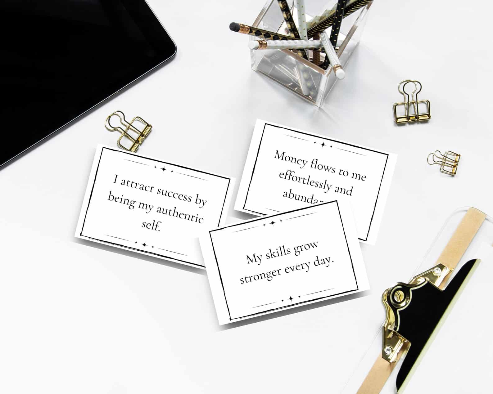 Manifestation cards are shown on a desk